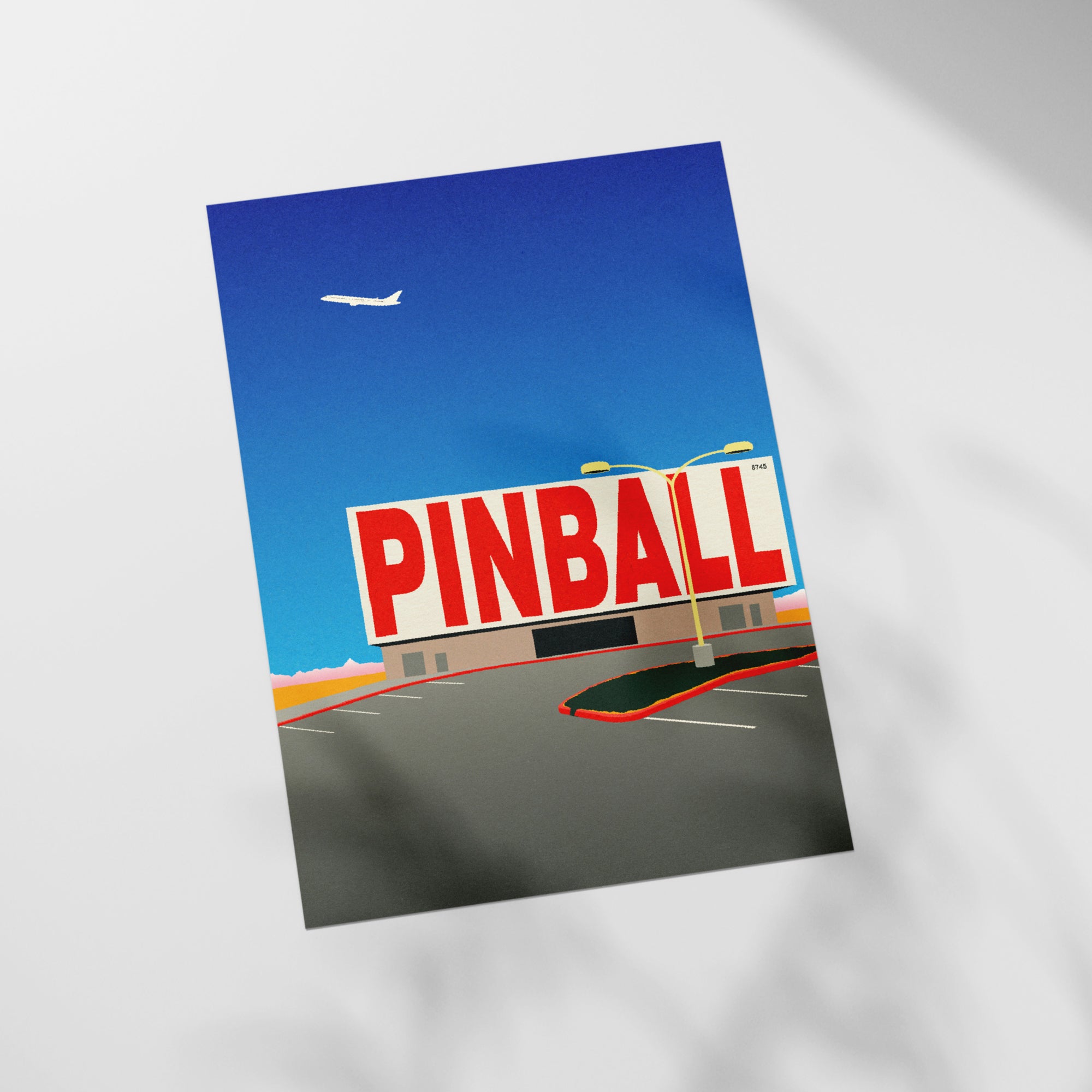 a pinball sign in front of a parking lot