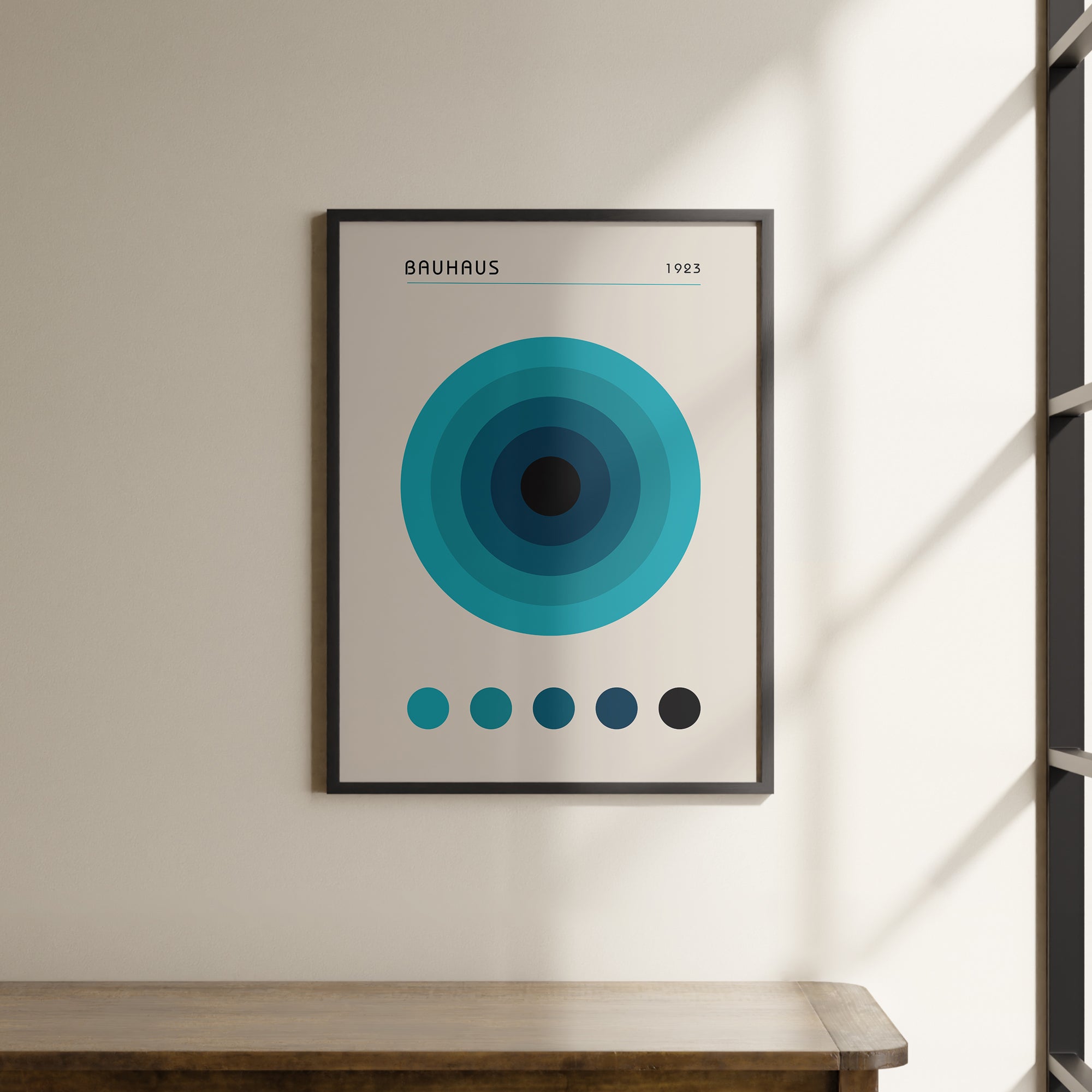 a picture hanging on a wall above a wooden table