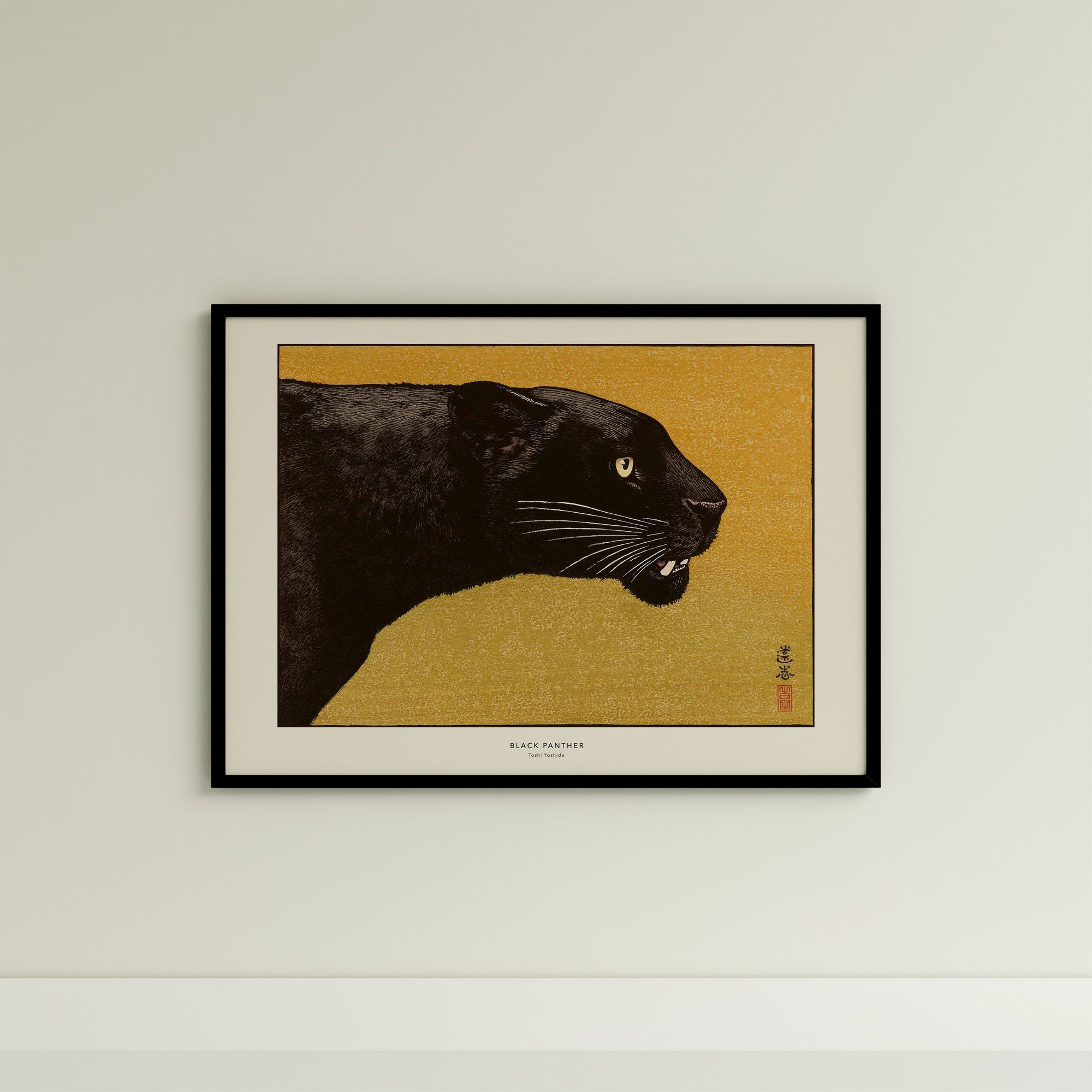 a framed picture of a black panther on a yellow background