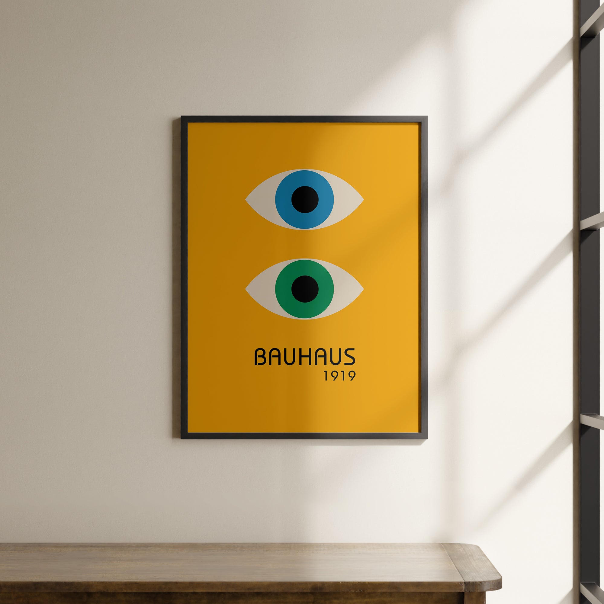 a picture hanging on a wall above a wooden table