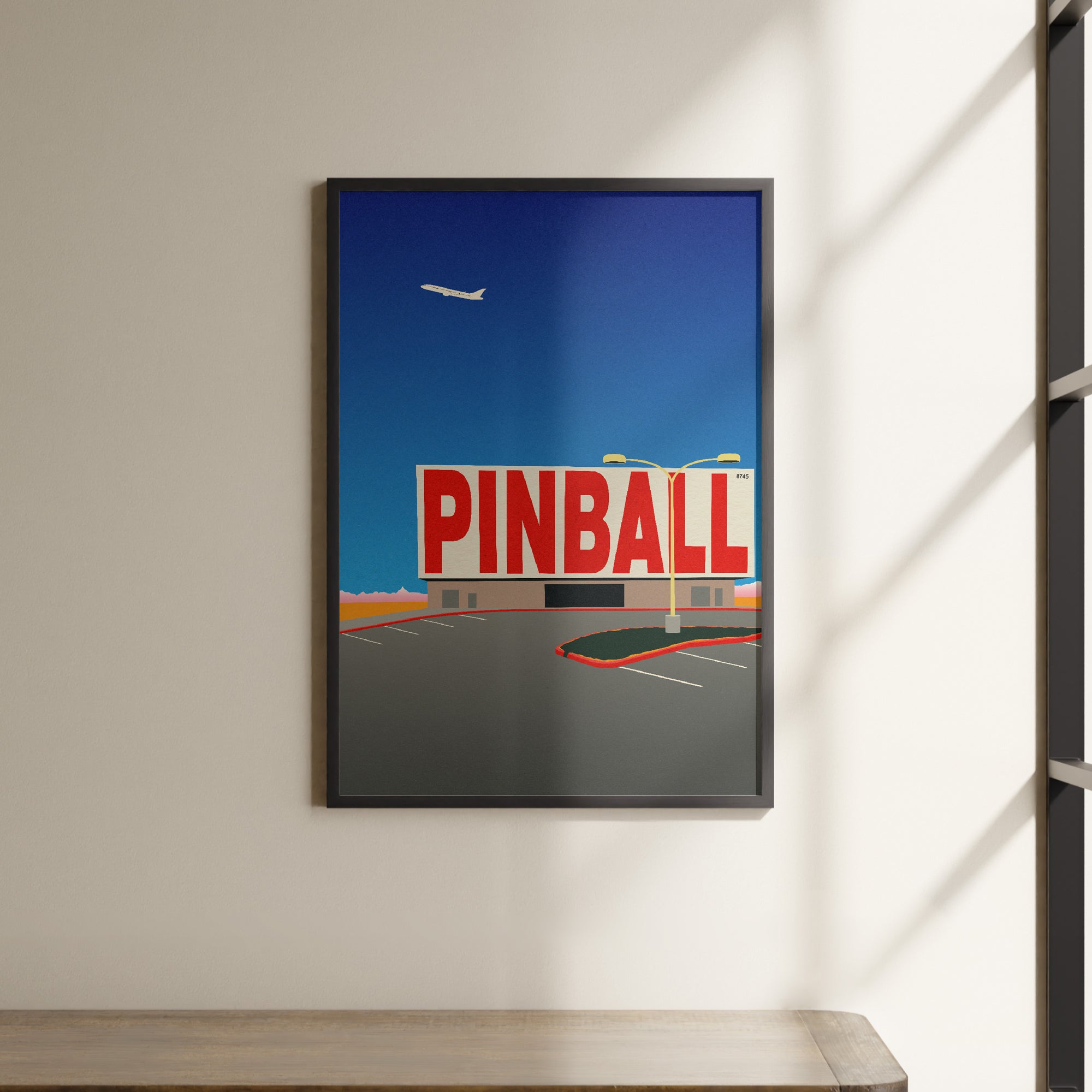 a picture of a pinball sign hanging on a wall