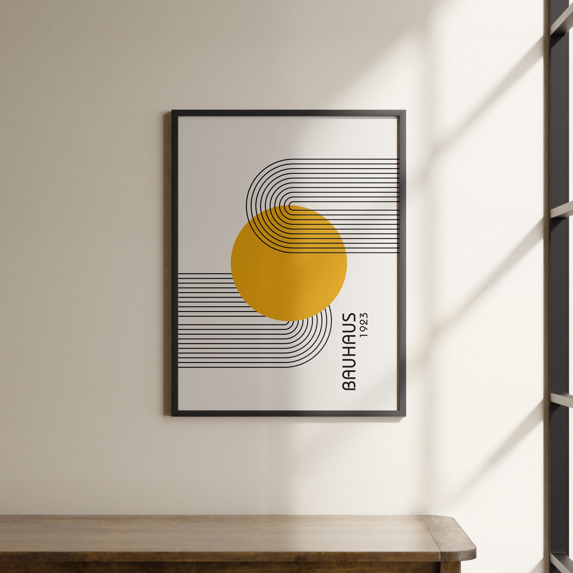 a picture hanging on a wall above a wooden table