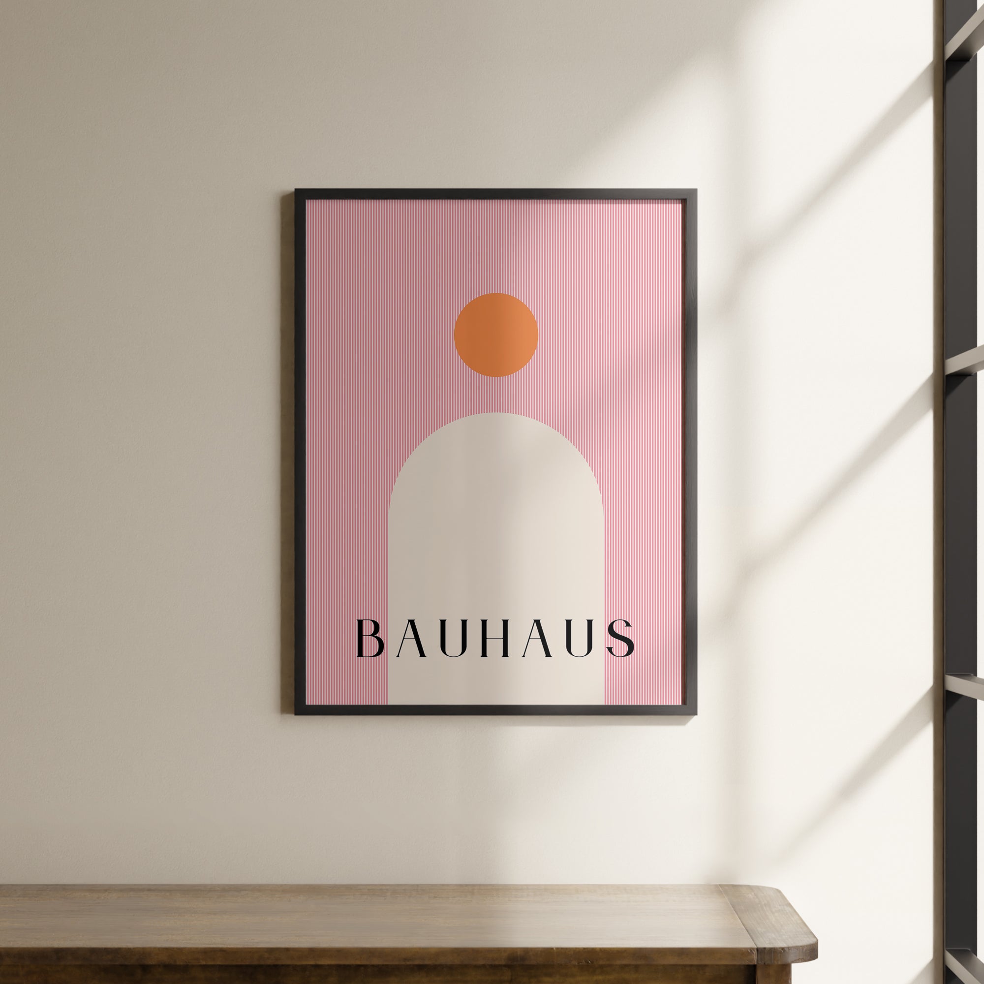 a picture hanging on a wall above a wooden table