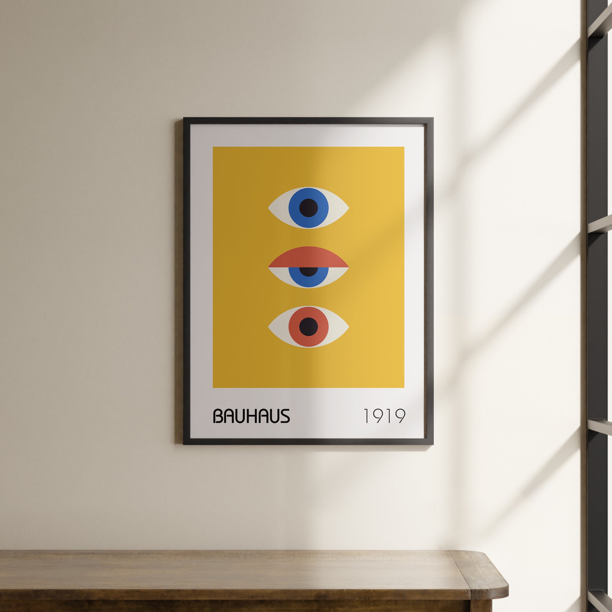 a picture hanging on a wall above a wooden table