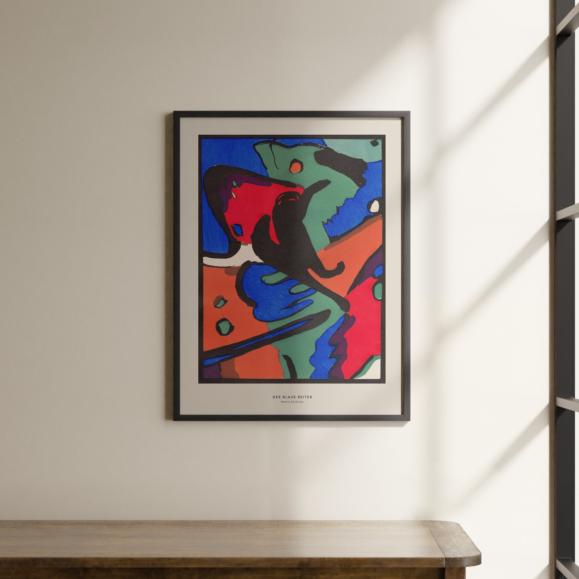 a painting hanging on a wall next to a wooden table