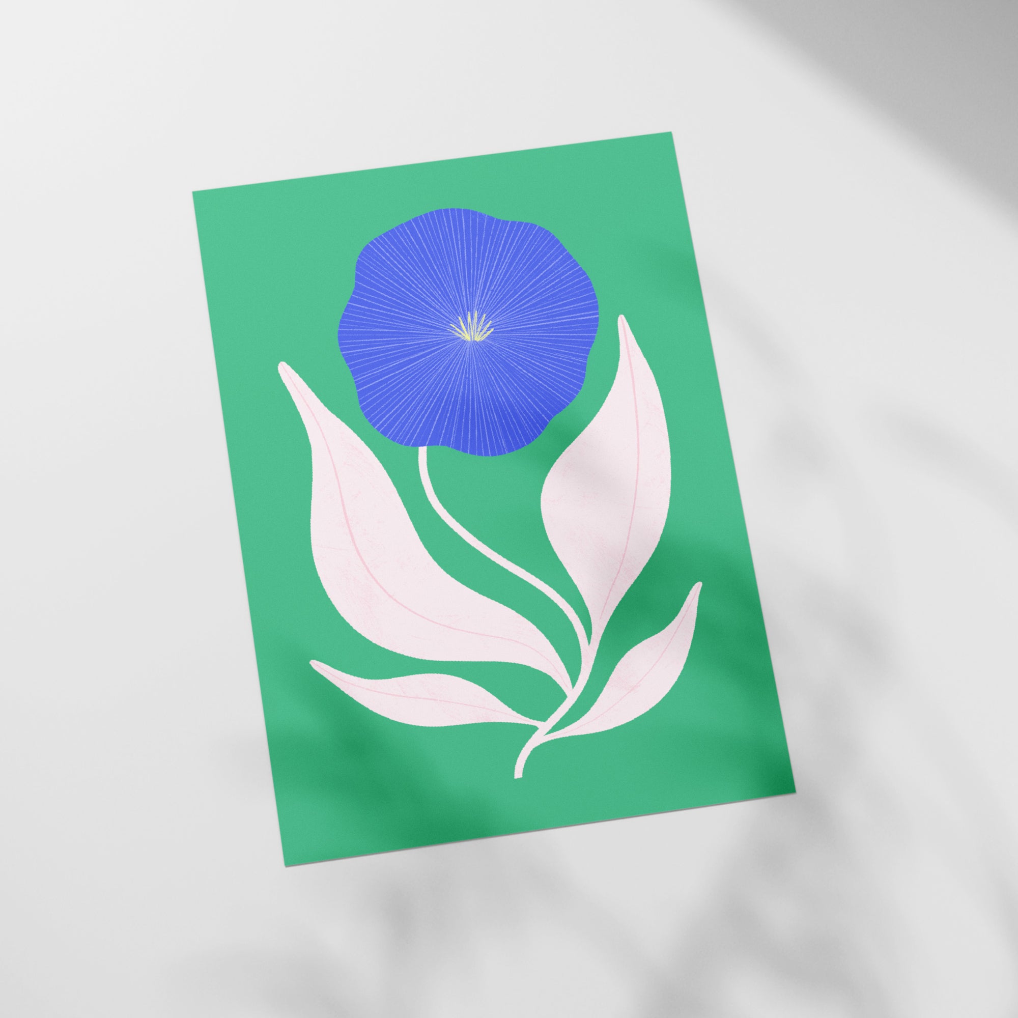 a picture of a blue flower on a green background