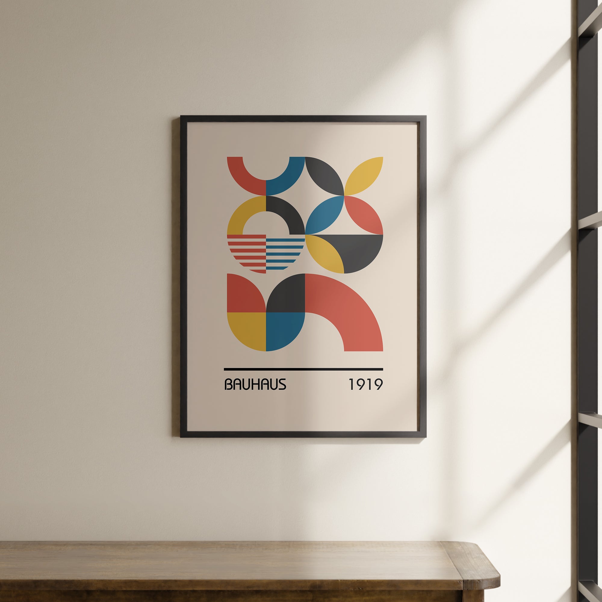 a picture hanging on a wall above a wooden table