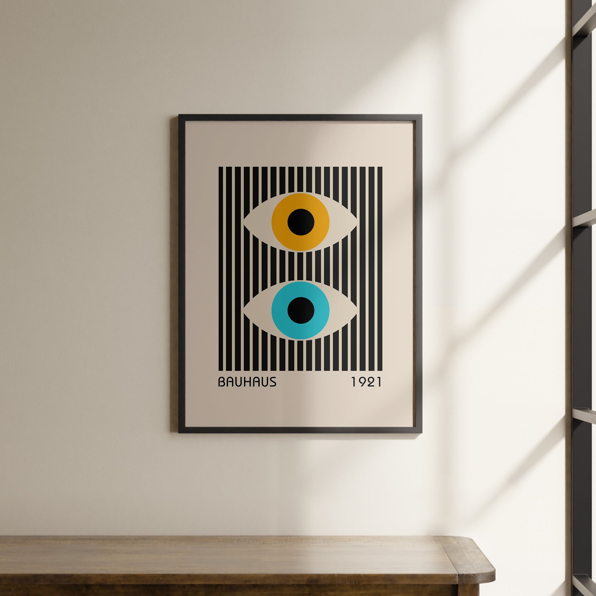 a picture hanging on a wall above a wooden table