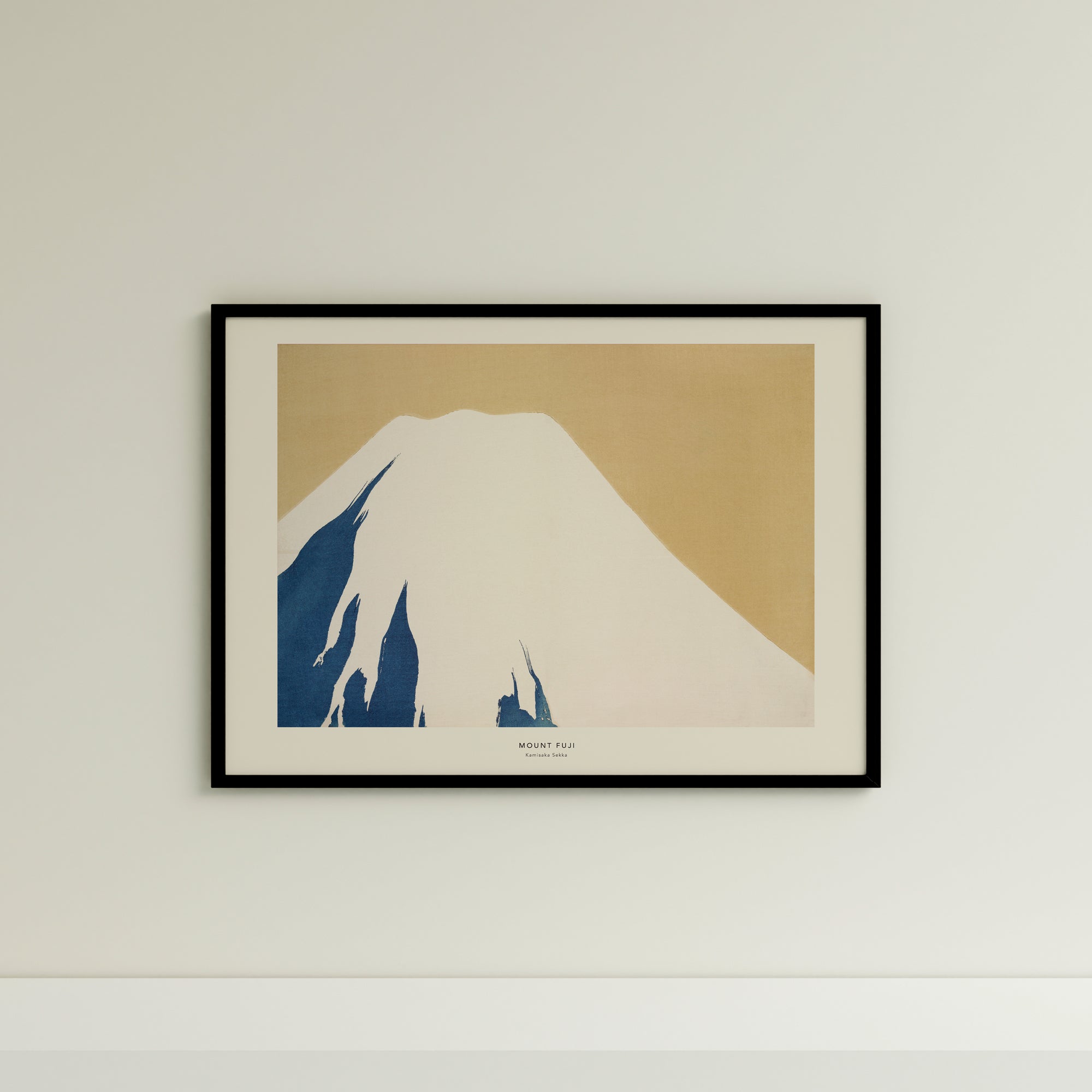 a picture of a mountain in a frame on a wall