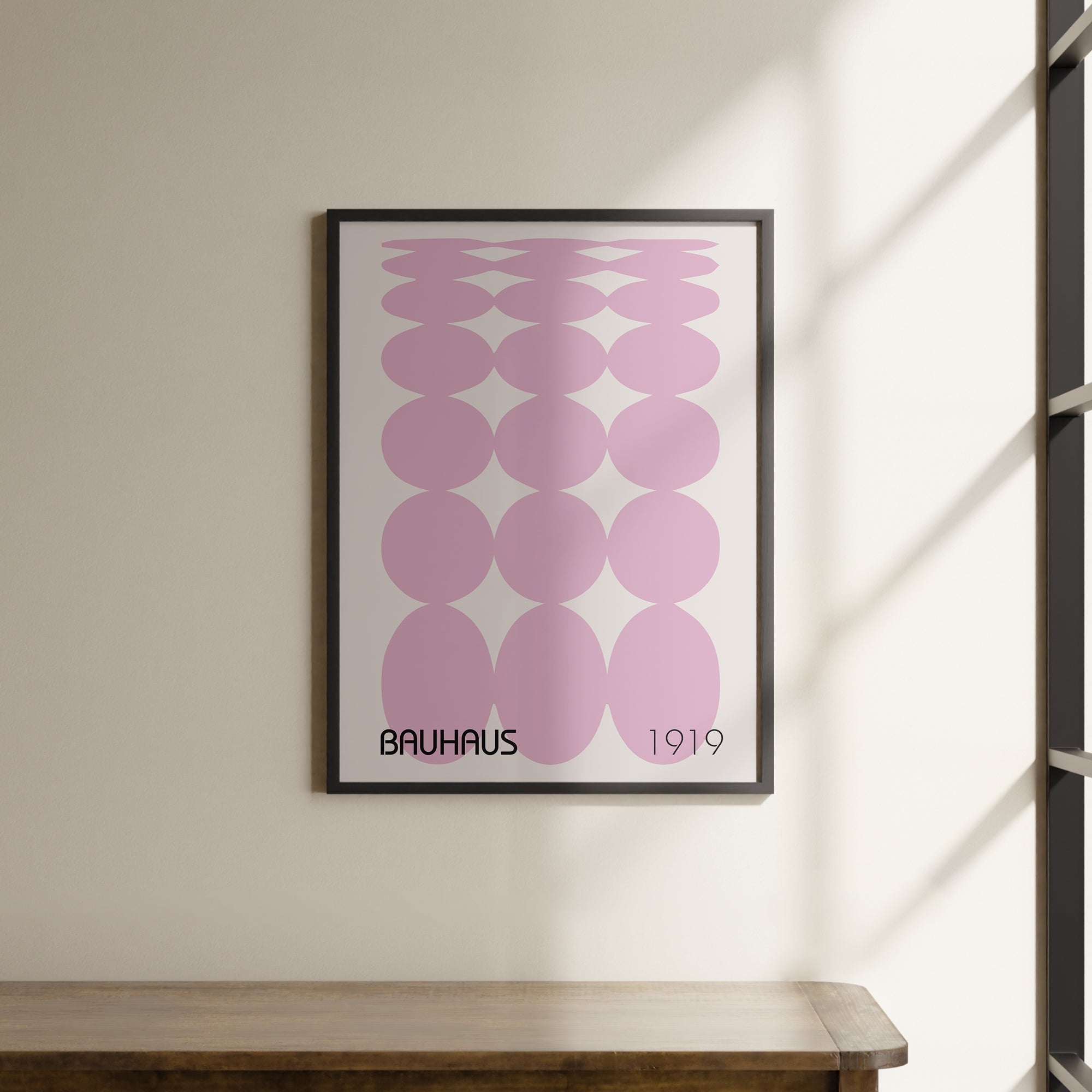 a picture hanging on a wall above a wooden table