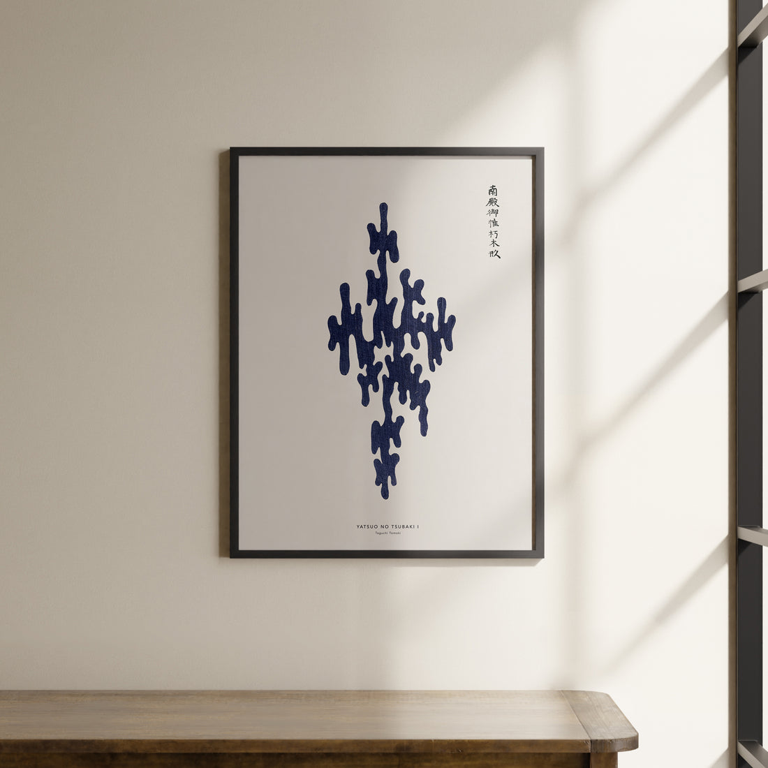 a picture hanging on a wall above a wooden table