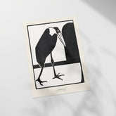 a black and white picture of a bird sitting on a window sill