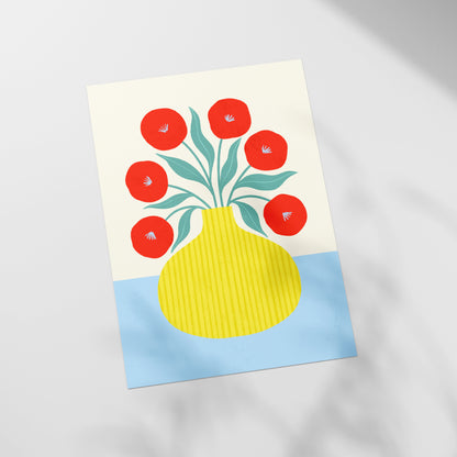 a picture of a yellow vase with red flowers