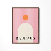 a pink and orange poster hanging on a wall