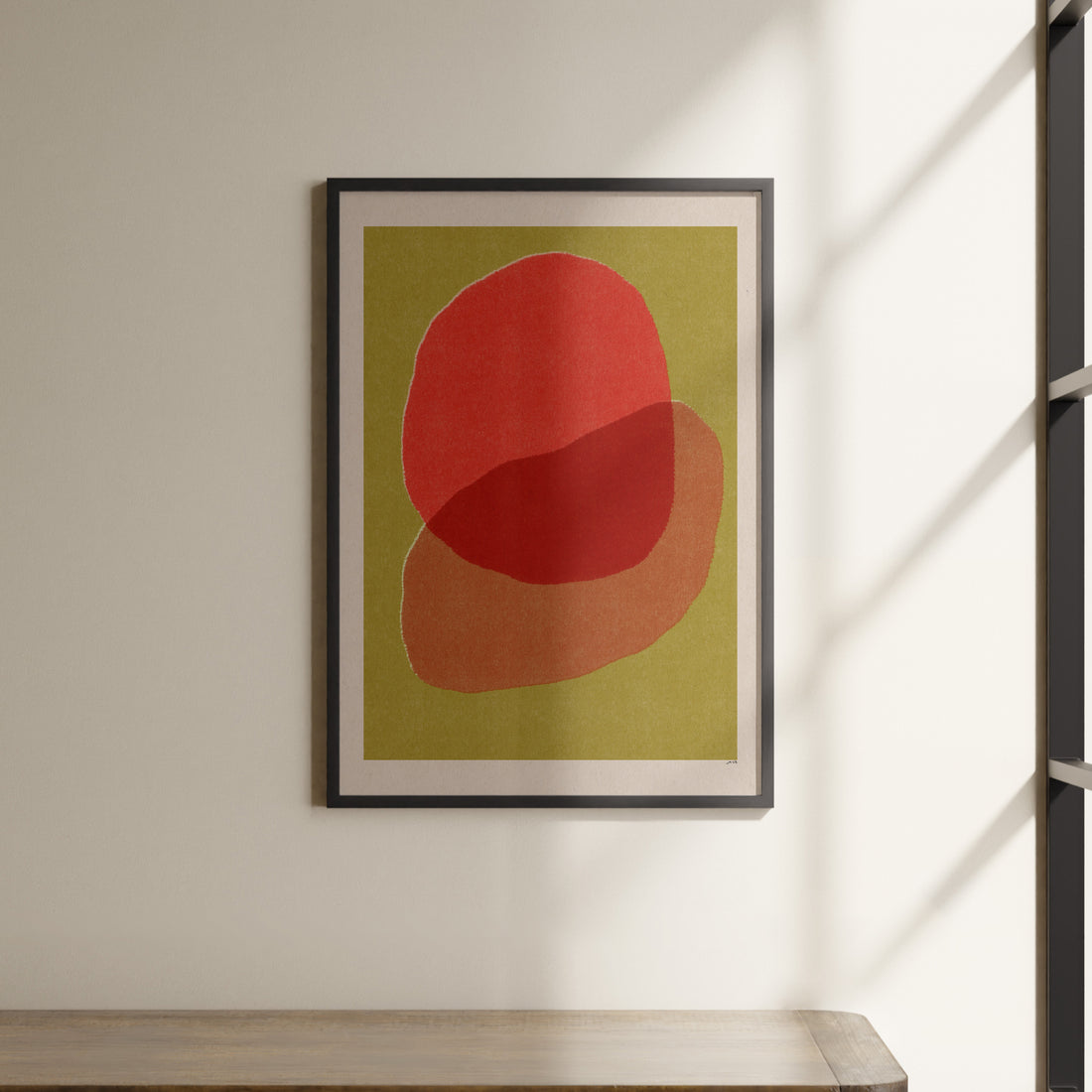 a picture hanging on a wall above a shelf