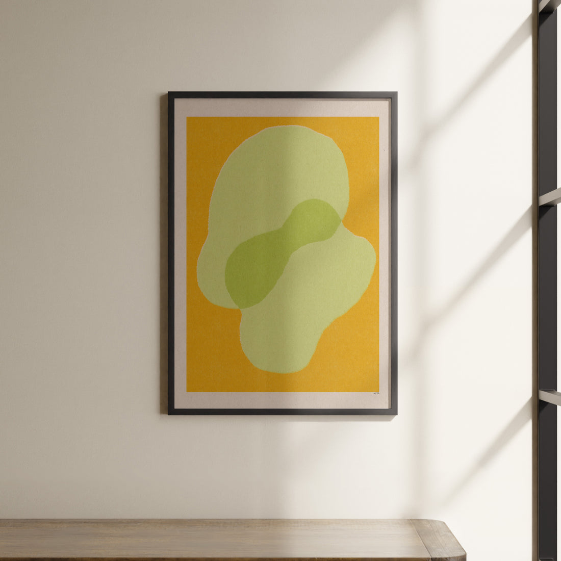 a picture hanging on a wall above a shelf