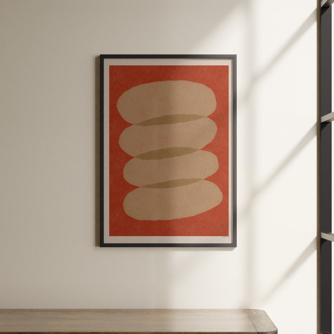 a picture hanging on a wall above a shelf