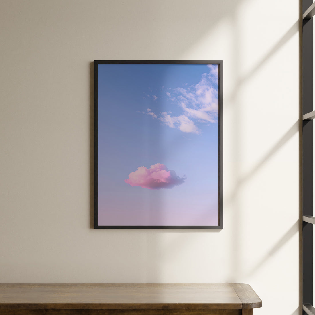 a picture of a pink cloud hanging on a wall