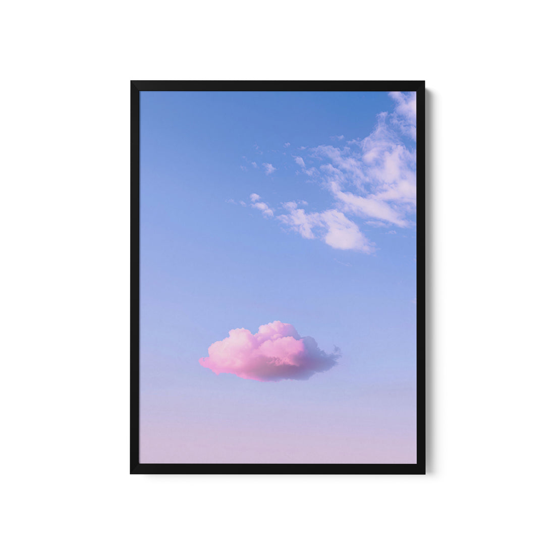 a pink cloud floating in a blue sky