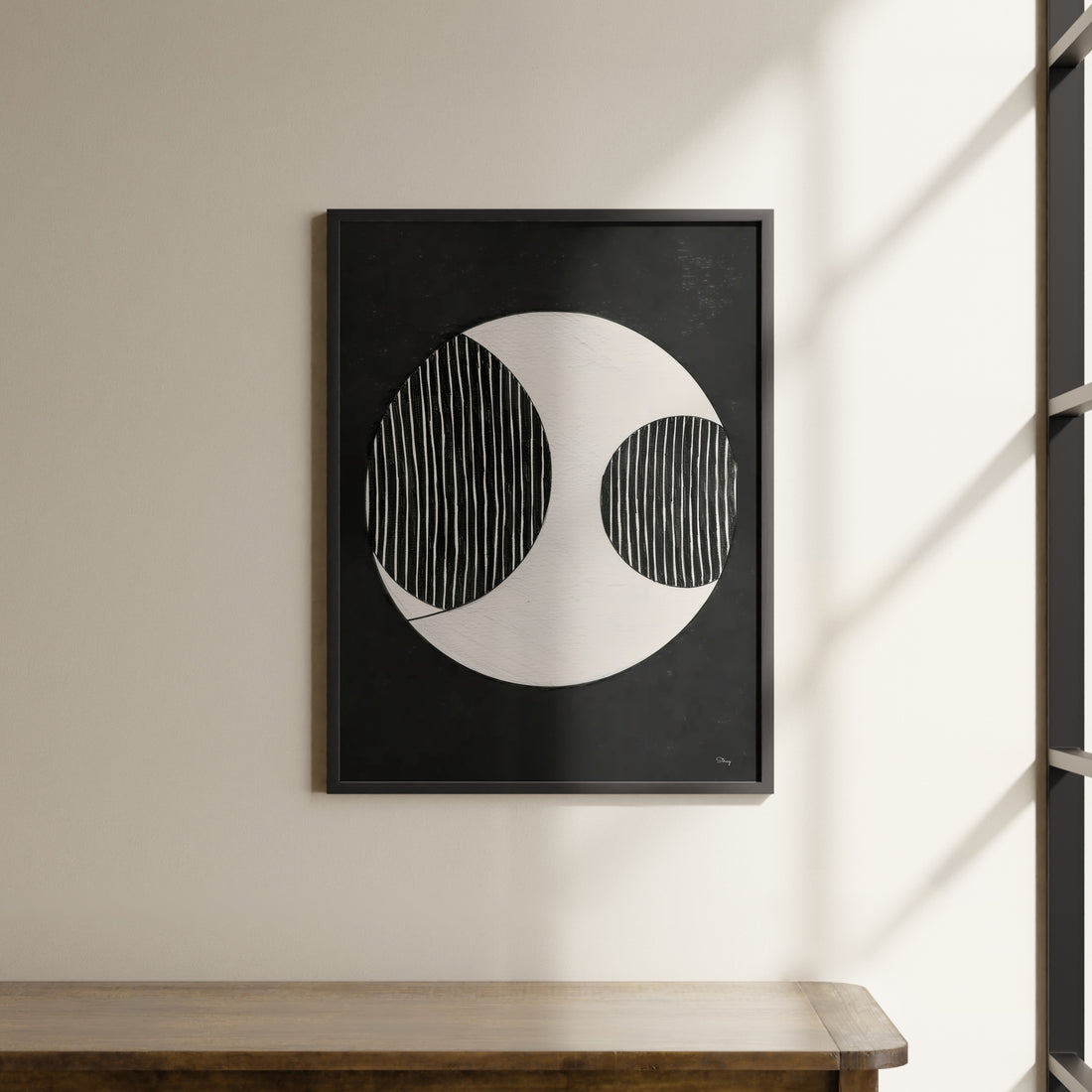 a black and white picture hanging on a wall