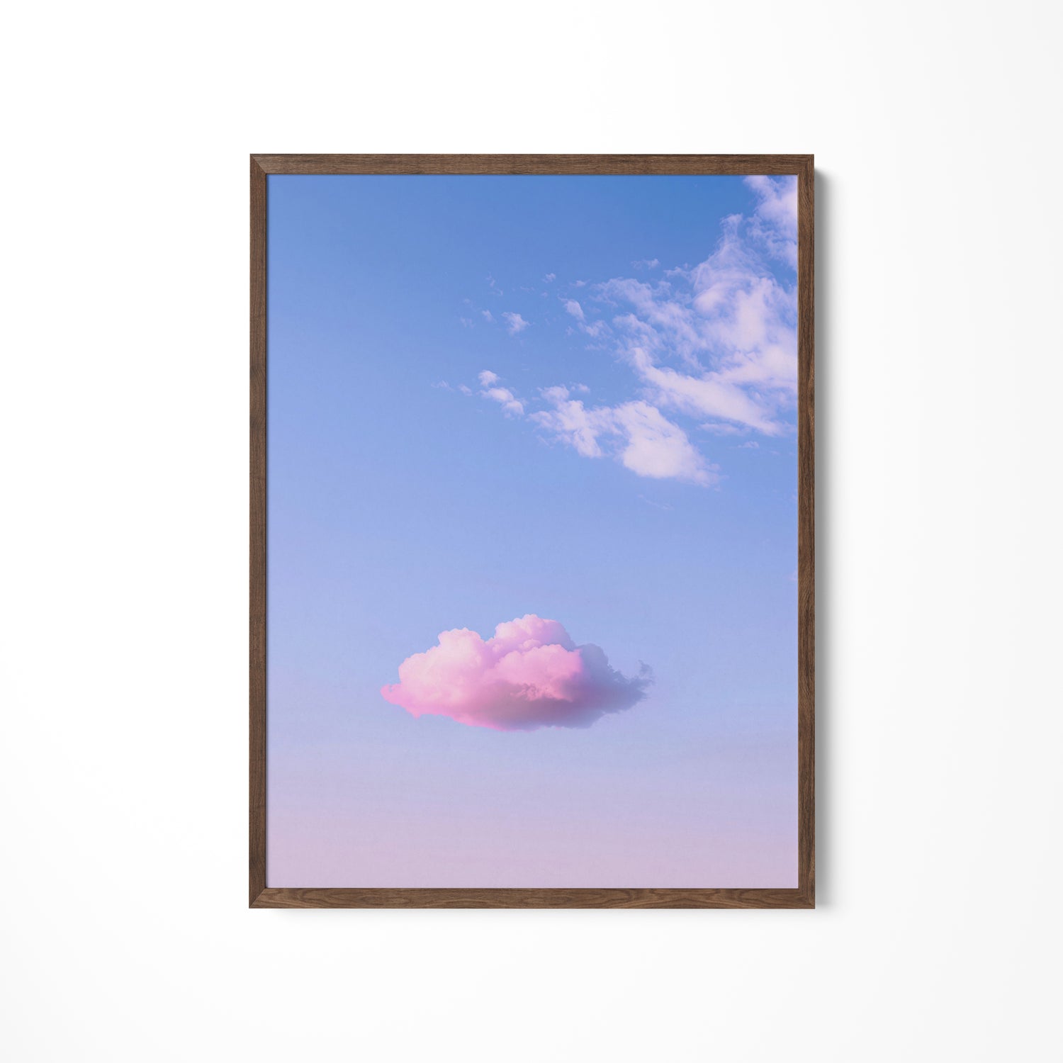 a pink cloud floating in a blue sky