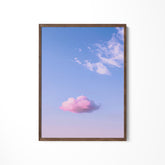 a pink cloud floating in a blue sky