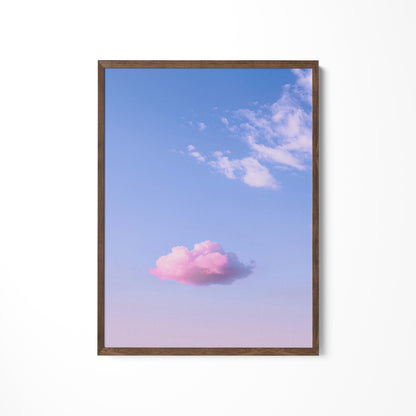 a pink cloud floating in a blue sky