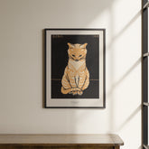 a picture of a cat is hanging on a wall