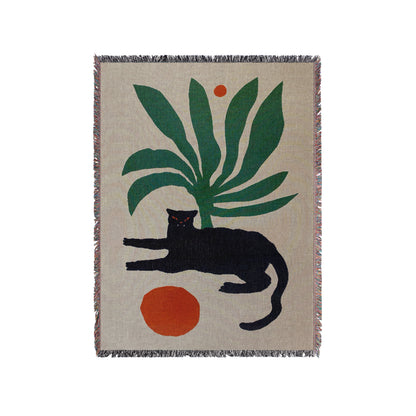 a black cat laying on top of a rug