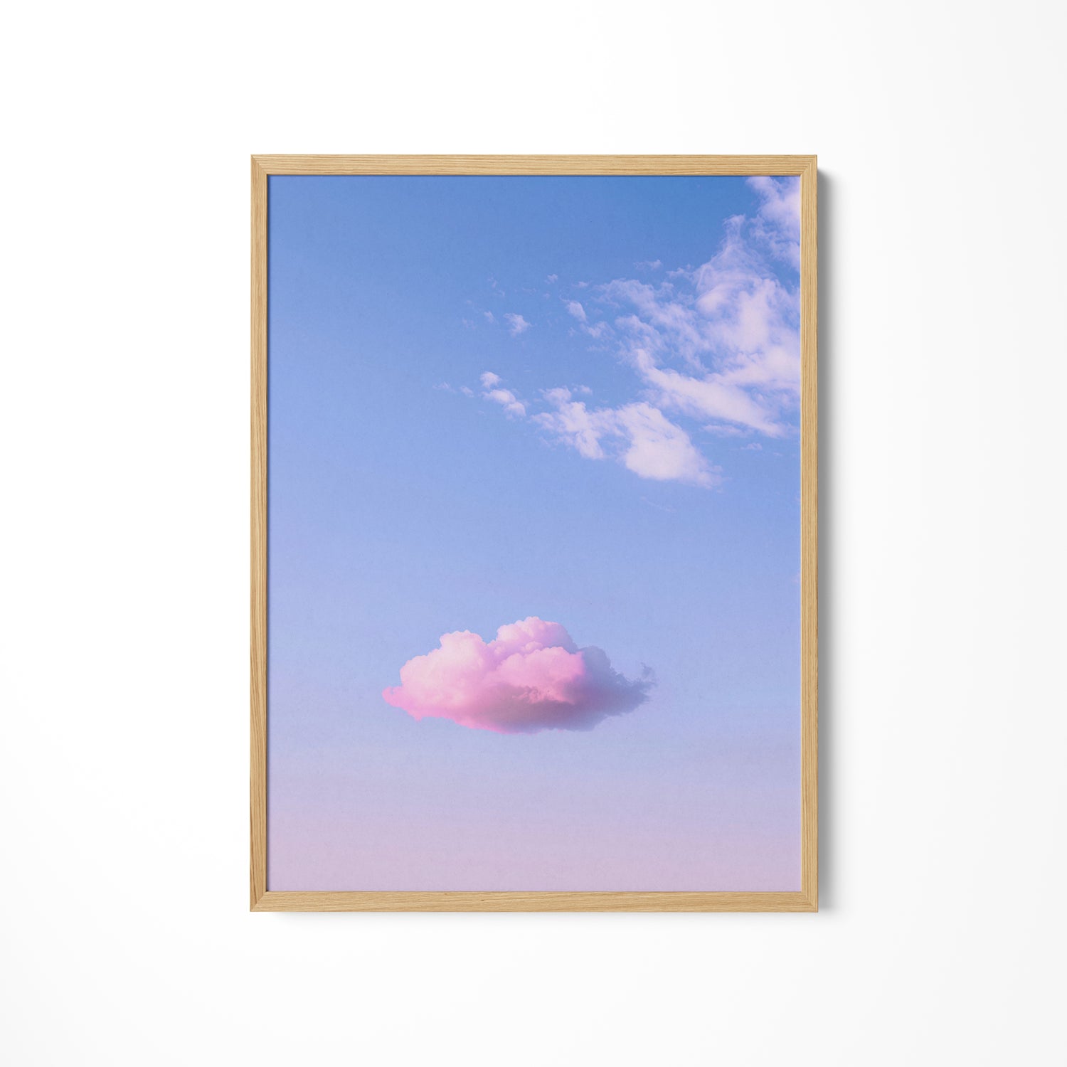 a pink cloud floating in a blue sky