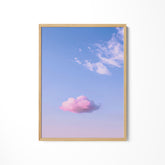 a pink cloud floating in a blue sky