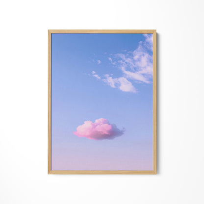 a pink cloud floating in a blue sky