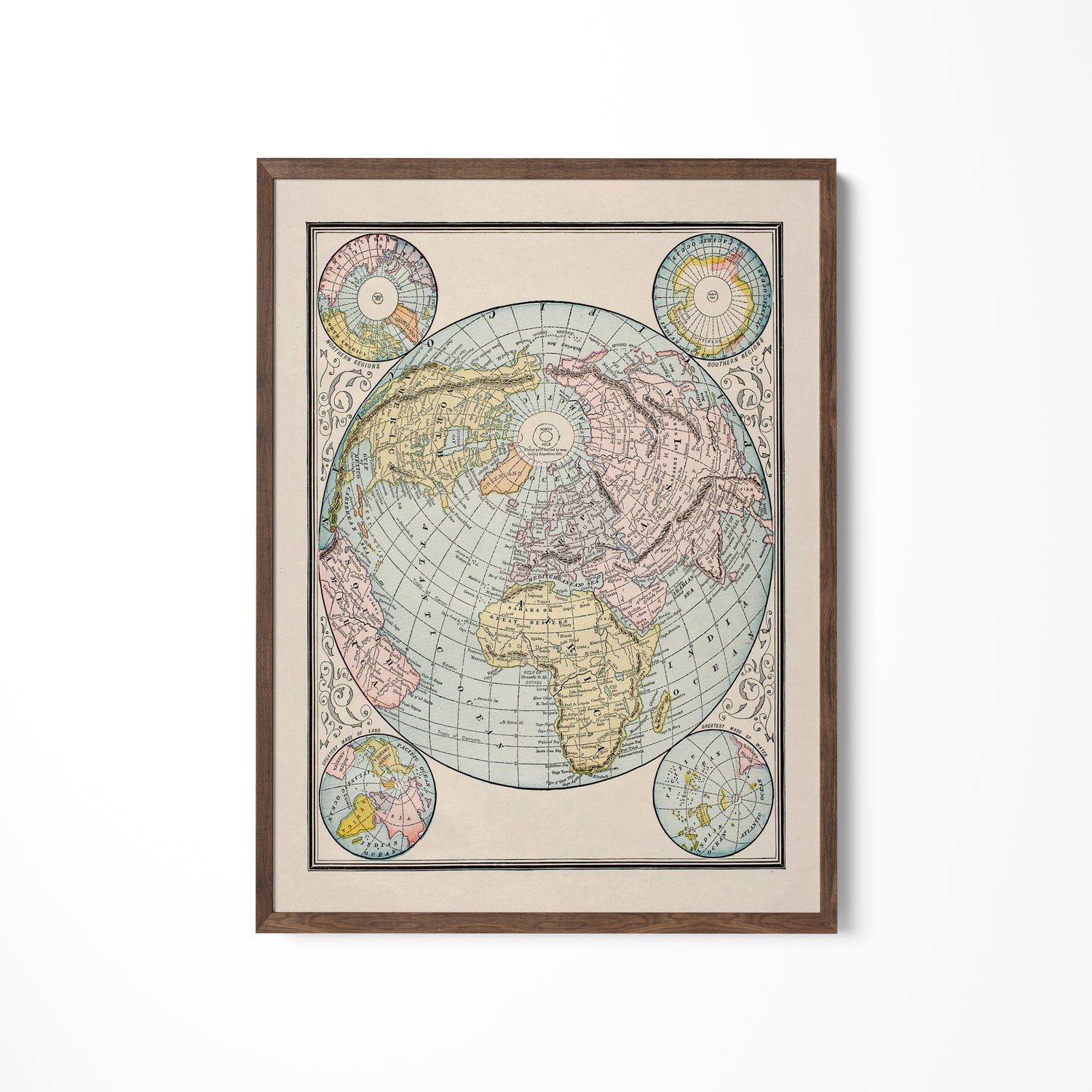 a framed map of the world hanging on a wall
