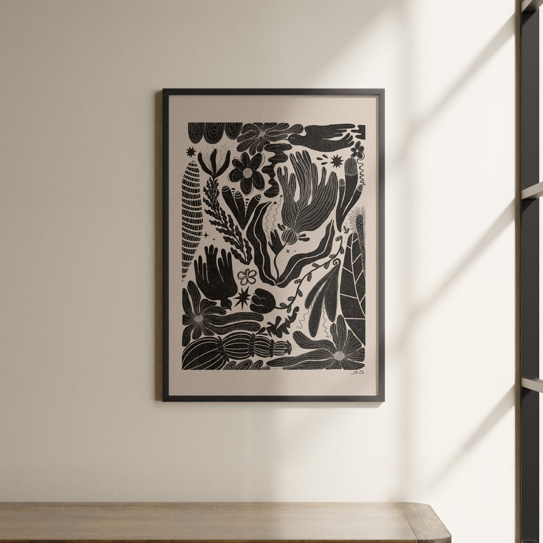 a picture hanging on a wall above a shelf