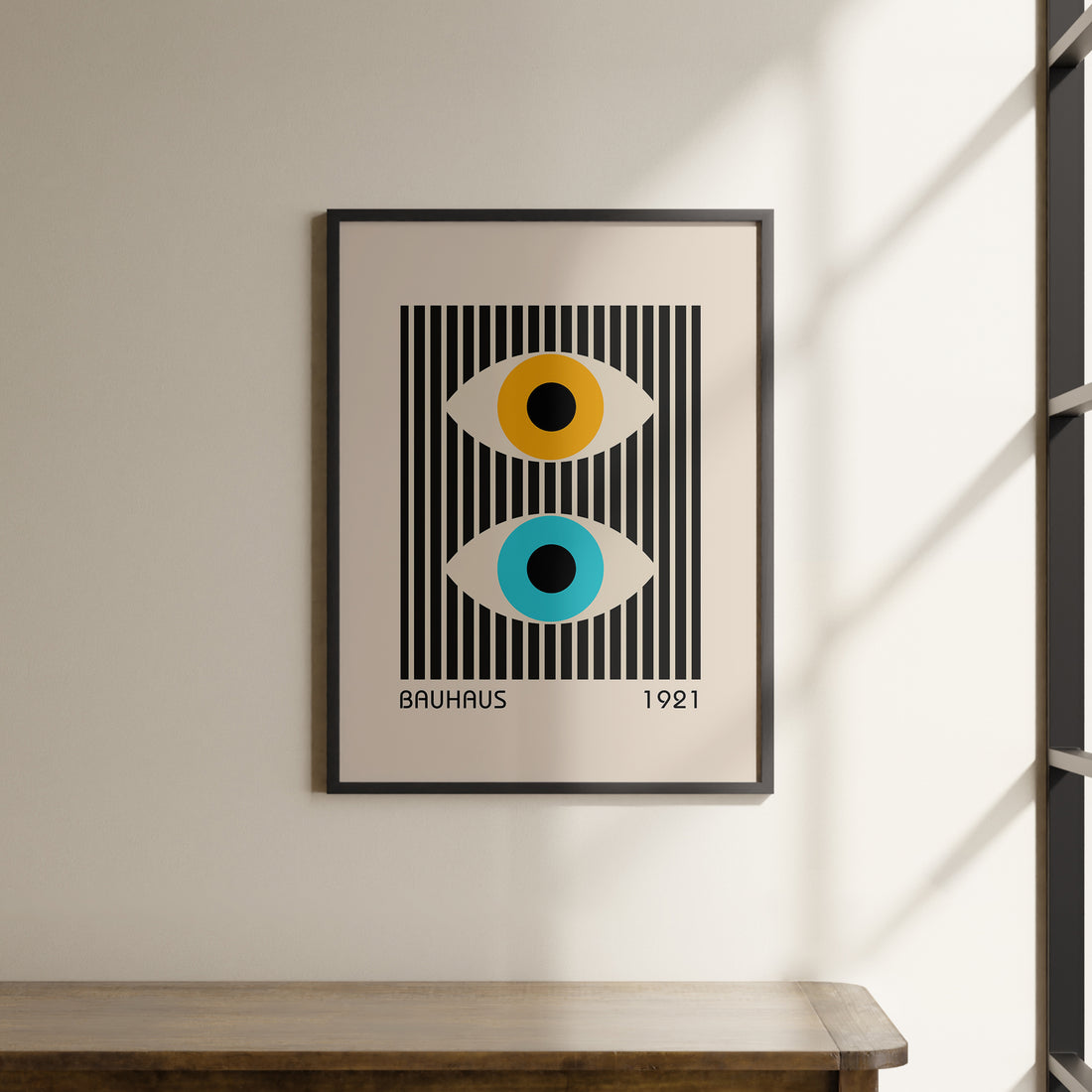 a picture hanging on a wall above a wooden table
