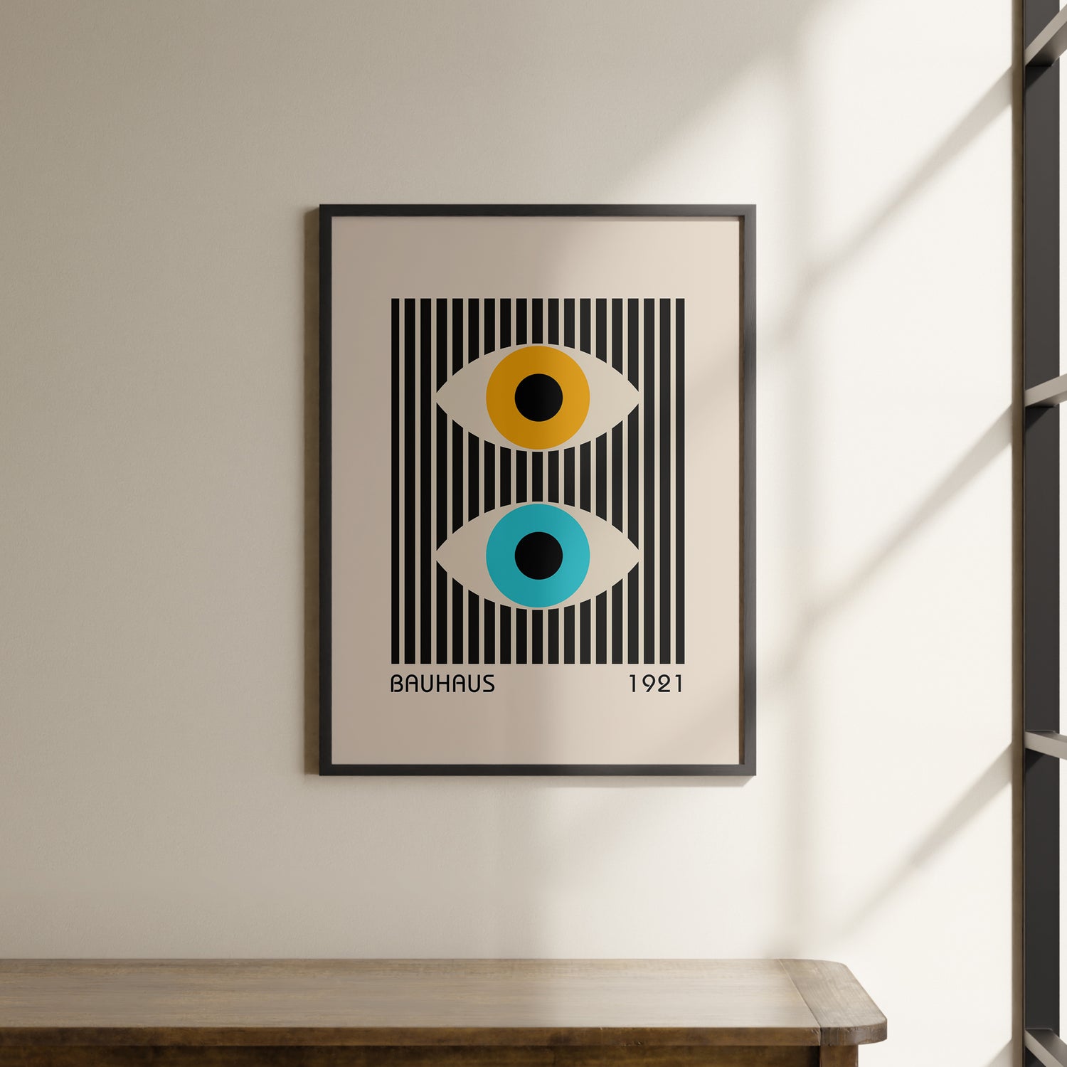 a picture hanging on a wall above a wooden table