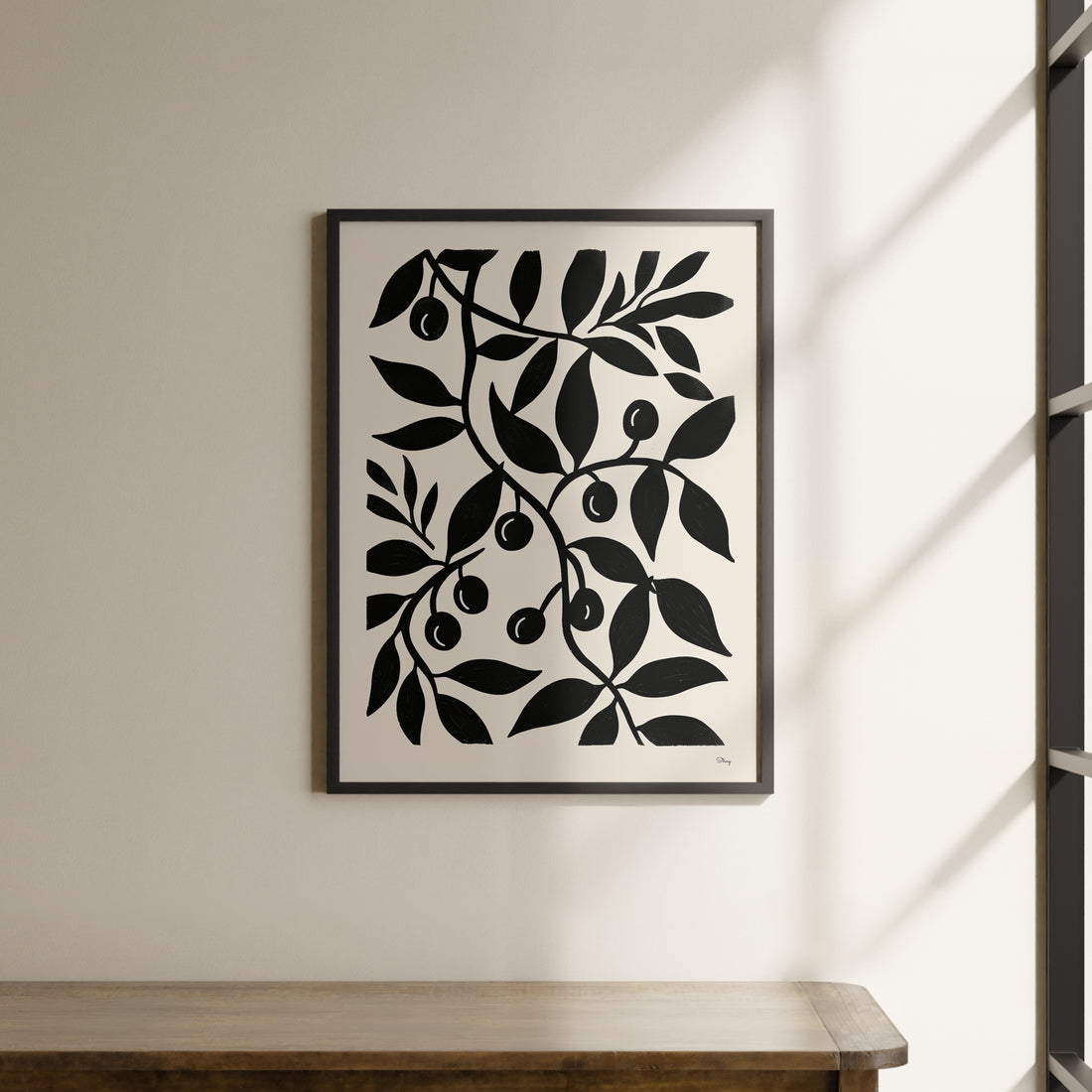 a black and white picture hanging on a wall