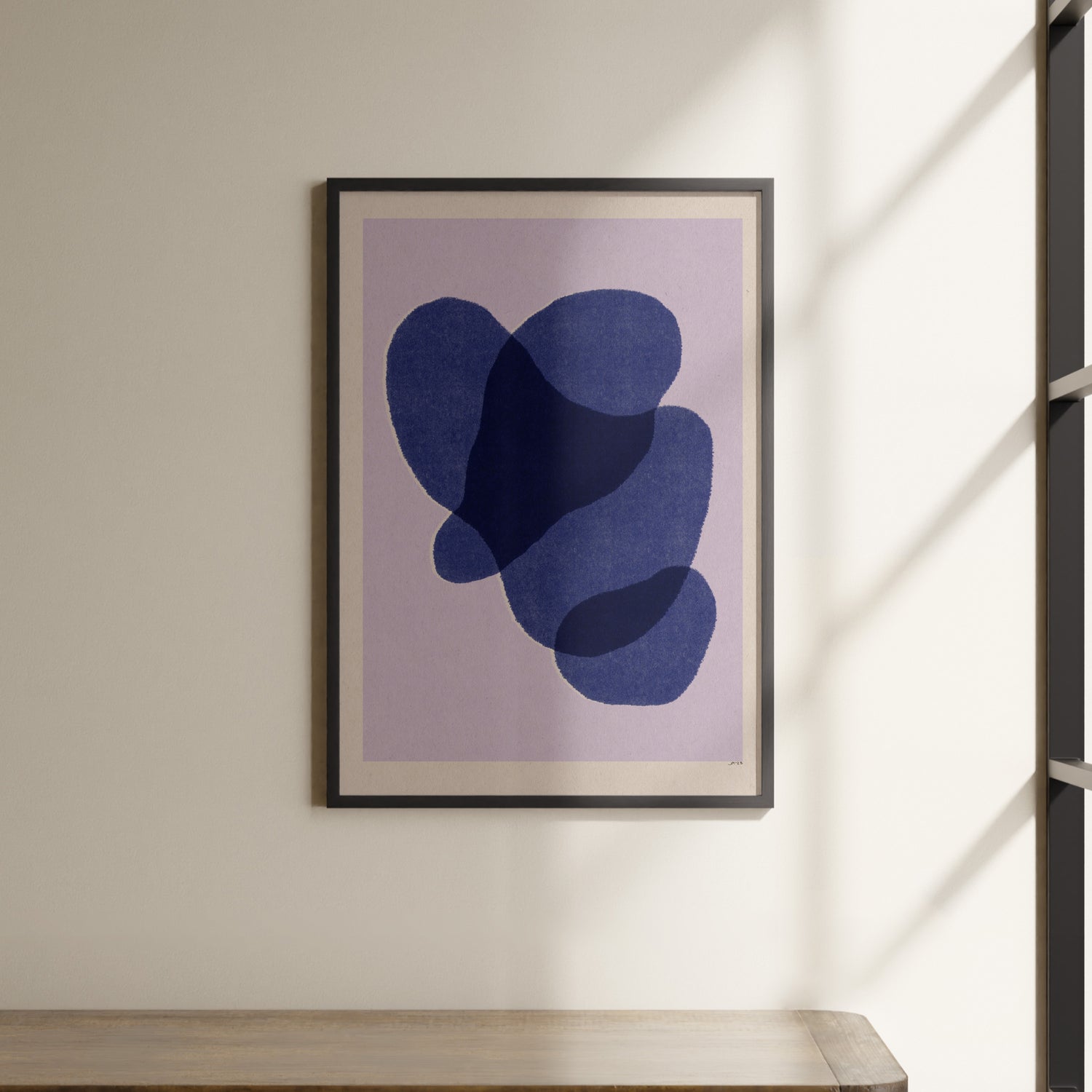 a picture hanging on a wall above a shelf