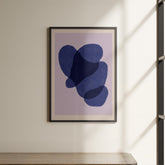 a picture hanging on a wall above a shelf