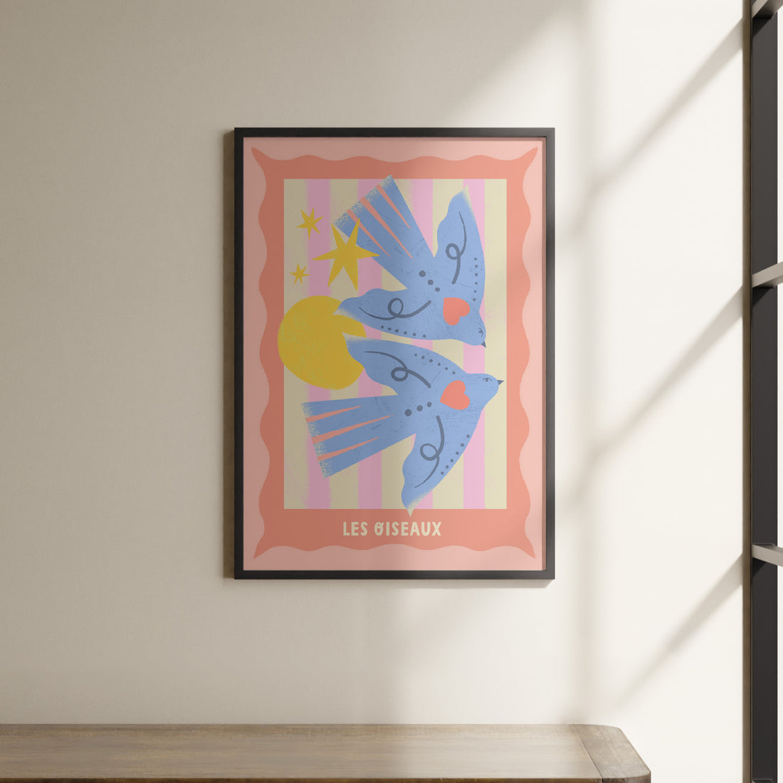 a picture hanging on a wall above a shelf