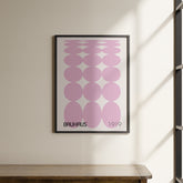 a picture hanging on a wall above a wooden table