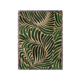 a green and black rug with a pattern of leaves