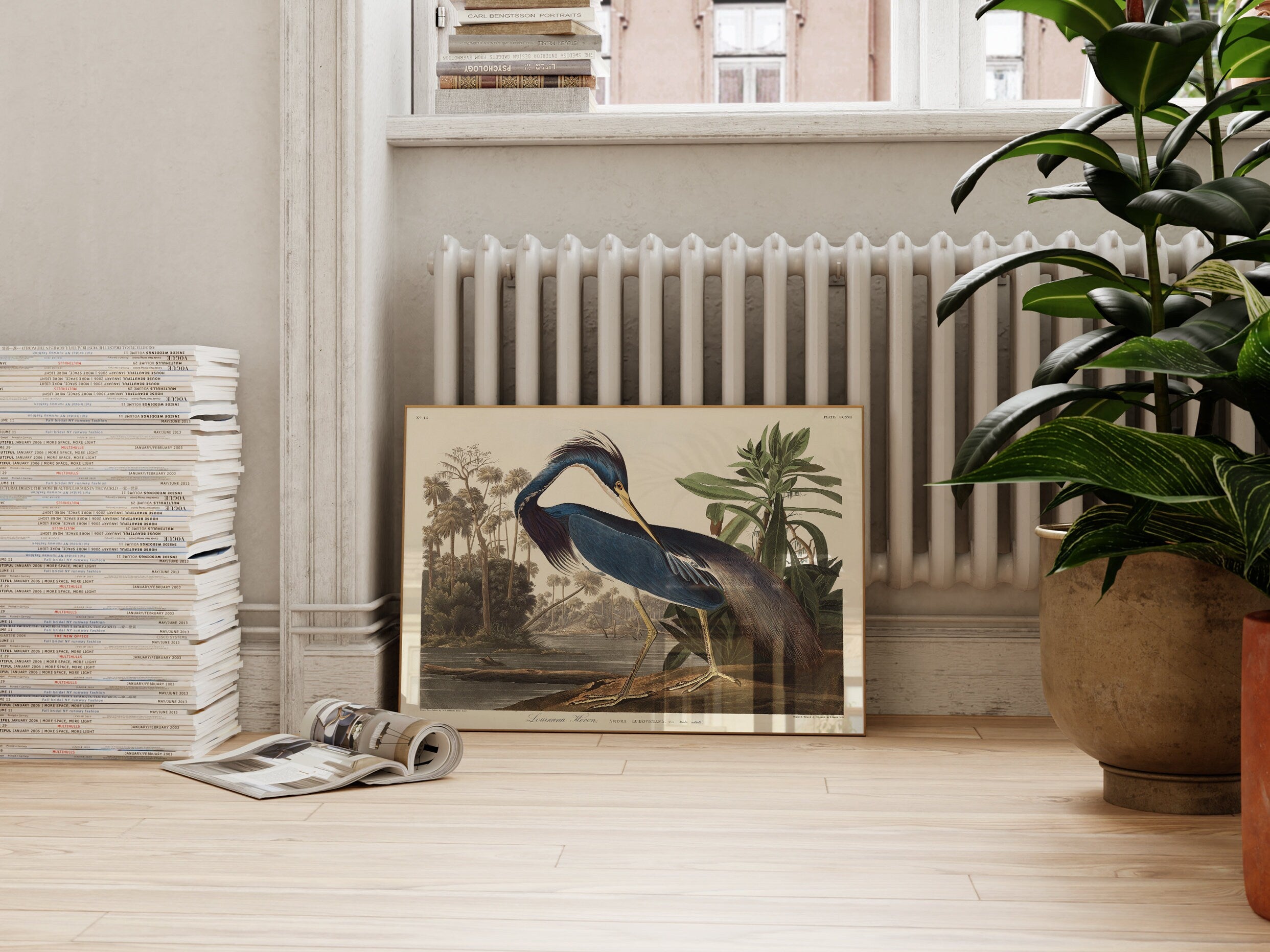 a picture of a bird on a table next to a potted plant